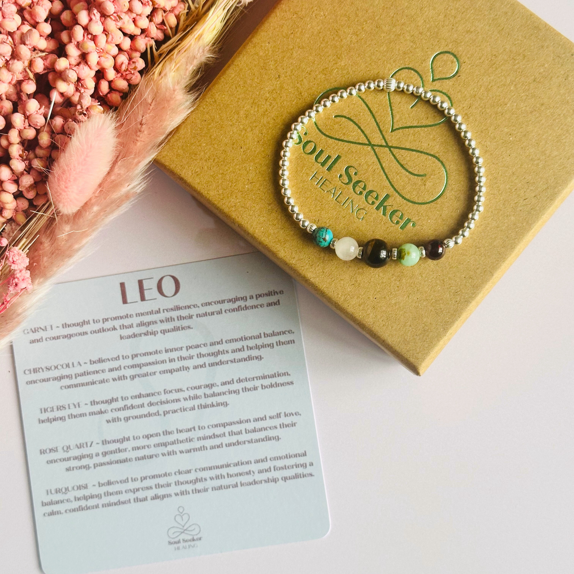 This sterling silver Leo bracelet is made with a selection of five healing crystals all believed to resonate with the Leo zodiac sign. The central bead is 8mm, the other four are 6mm. On an elasticated band of 3mm sterling silver beads with corrugated accent beads. Featuring chrysocolla, garnet, tigers eye, rose quartz and turquoise.