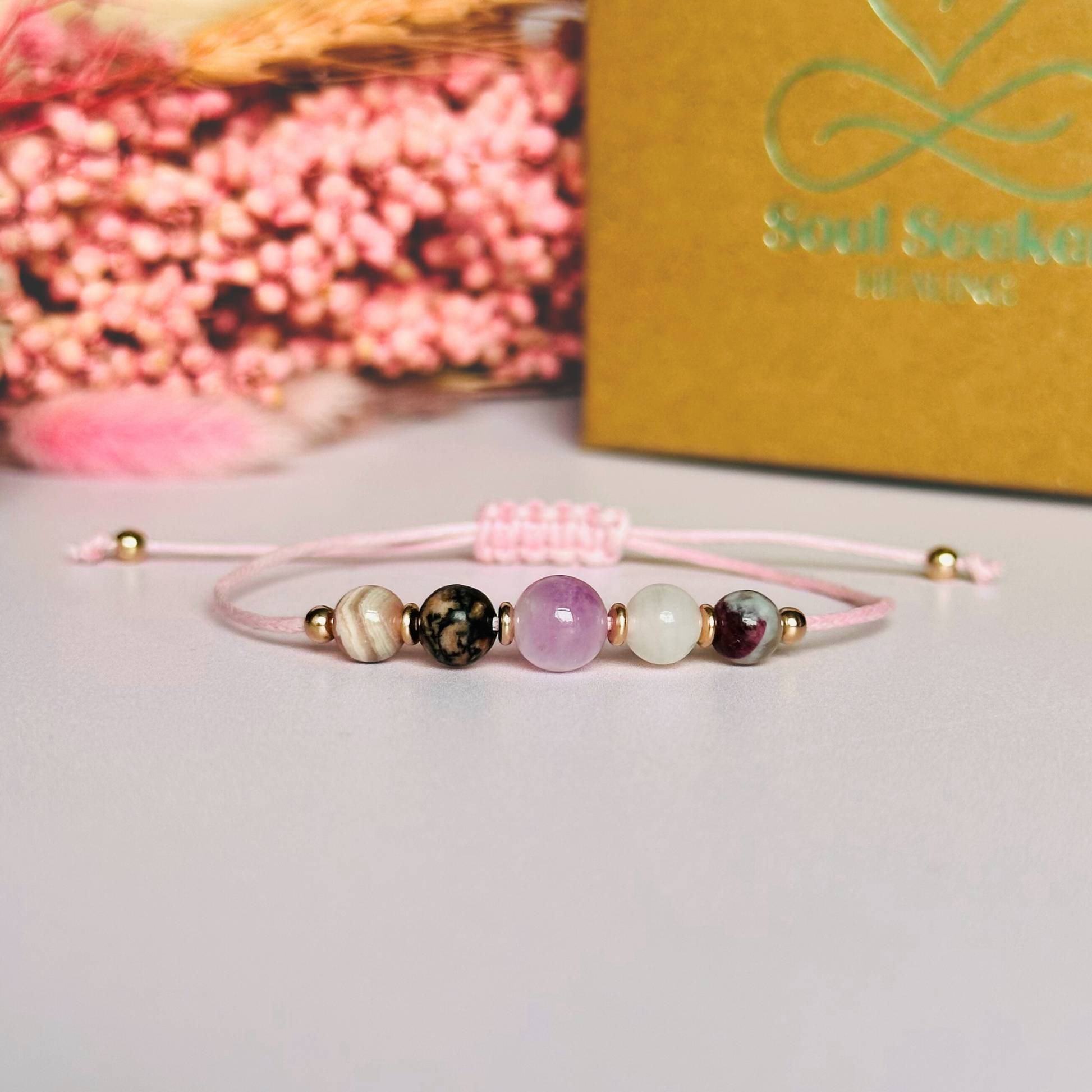Cord bracelet made with five crystals all believed to help with self-love. Including kunzite, rubellite, rose quartz, rhodonite and rhodochrosite. With your choice of cord colour and choice of either sterling silver, gold vermeil or rose gold vermeil accent beads. Vegan friendly waxed cotton cord.