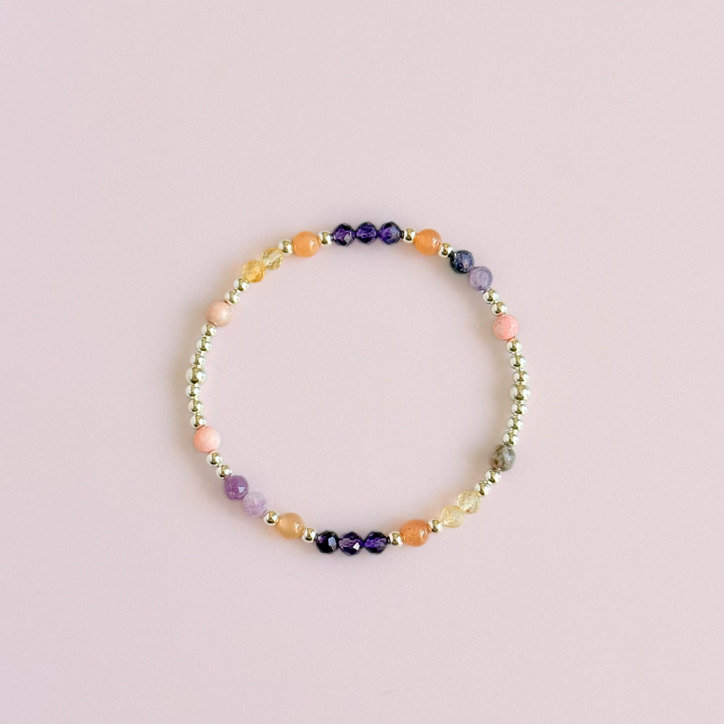 Dainty sterling silver crystal bracelet featuring five crystals, in 4mm faceted and smooth round style, each believed to help with menopause symptoms. Featuring amethyst, citrine, lepidolite, peach moonstone and pink zebra jasper. Pictured from above.