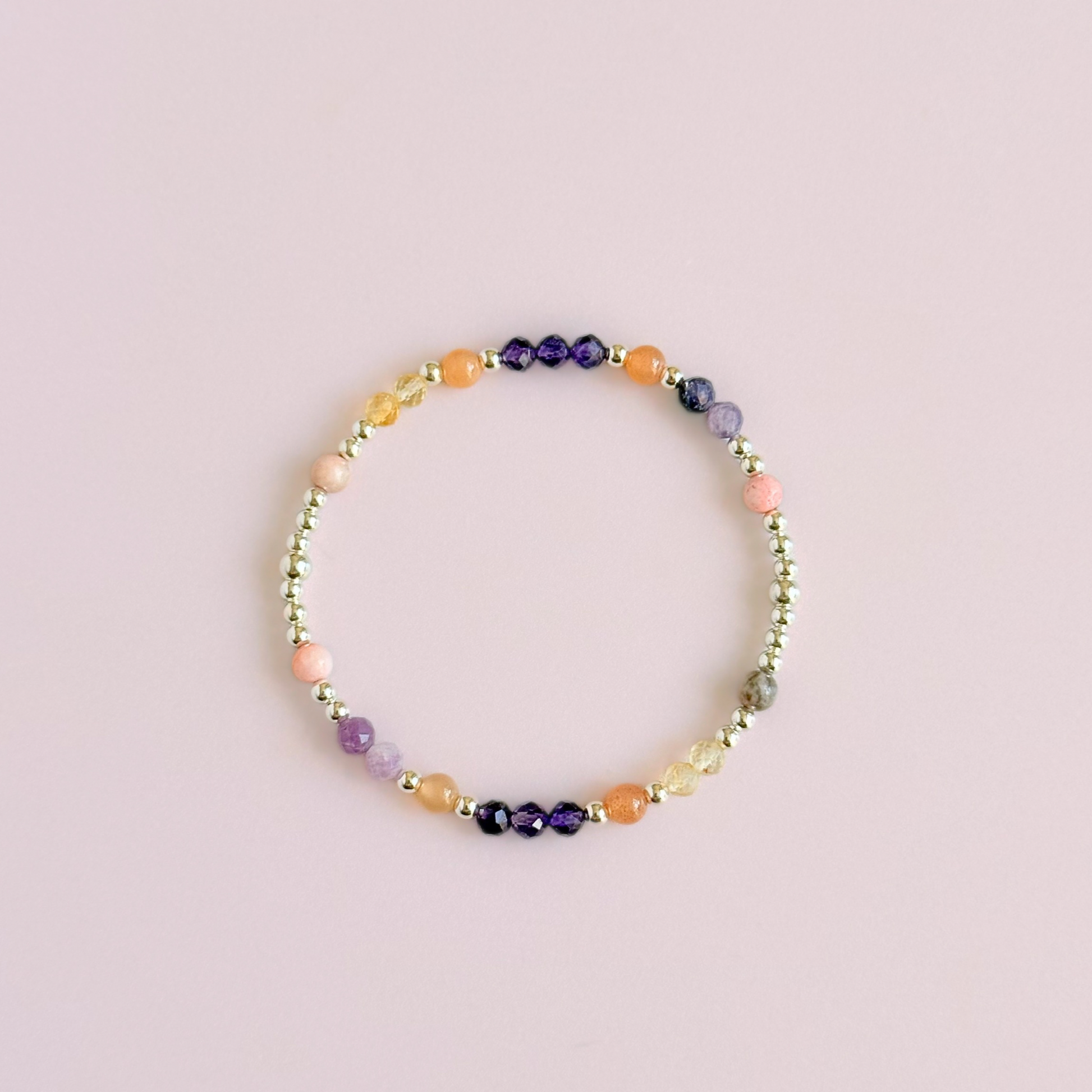 Dainty sterling silver crystal bracelet featuring five crystals, in 4mm faceted and smooth round style, each believed to help with menopause symptoms. Featuring amethyst, citrine, lepidolite, peach moonstone and pink zebra jasper. Pictured from above.