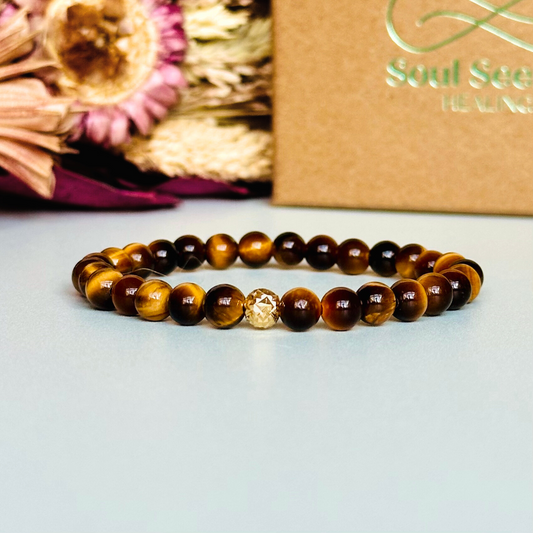 Tigers Eye bracelet featuring 6mm smooth tiger eye beads. With your choice of gold vermeil or sterling silver faceted accent beats.