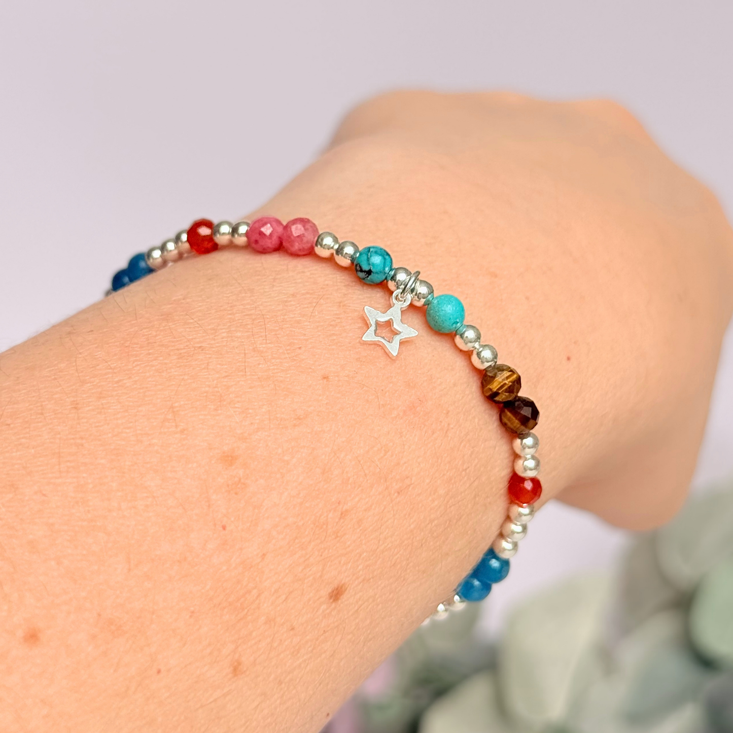 'Hot girl summer' sterling silver dainty beaded bracelet with tigers eye, turquoise, apatite, carnelian and rhodochrosite. With a beautiful open star charm. Made with round 3mm sterling silver beads and 4mm smooth and faceted round crystal gemstone beads. Pictured being worn.