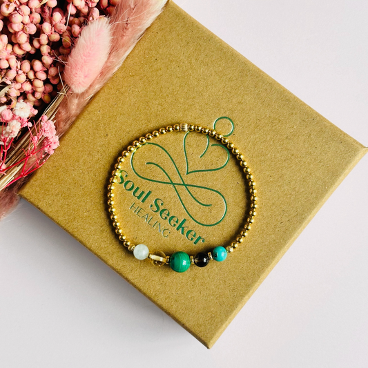 This gold vermeil Scorpio bracelet is made with a selection of five healing crystals all believed to resonate with the Scorpio zodiac sign. The central bead is 8mm, the other four are 6mm. On an elasticated band of 3mm gold vermeil beads with corrugated accent beads. Featuring aquamarine, citrine, malachite, smoky quartz and turquoise.