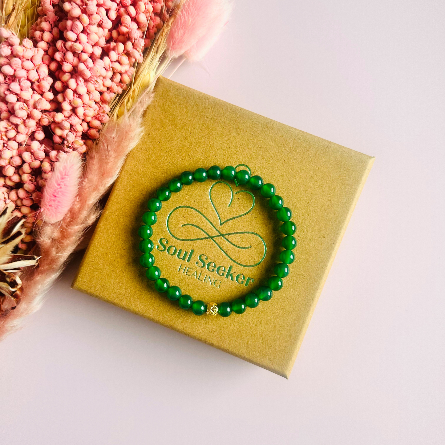 Green agate crystal healing bracelet made with 6mm smooth, round green agate beads and your choice of sterling silver or gold vermeil 6mm faceted focal bead. Elasticated for comfort.