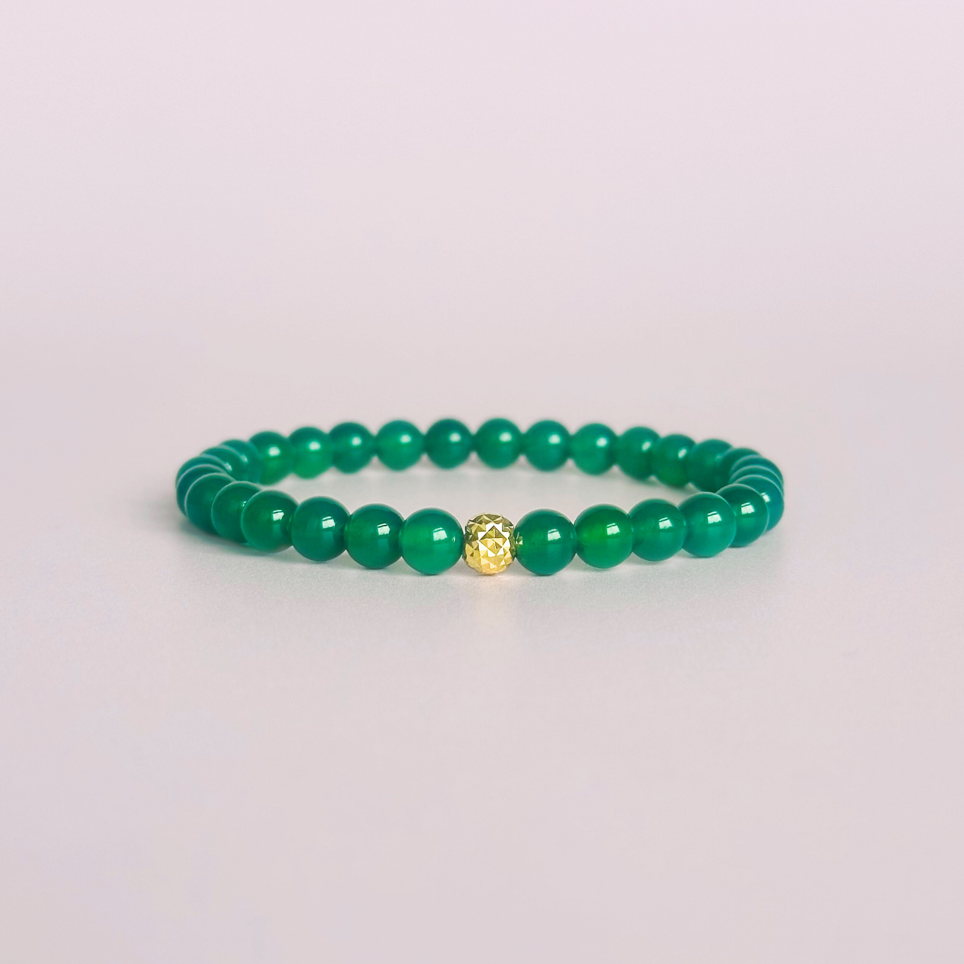 Green agate crystal healing bracelet made with 6mm smooth, round green agate beads and your choice of sterling silver or gold vermeil 6mm faceted focal bead. Elasticated for comfort.