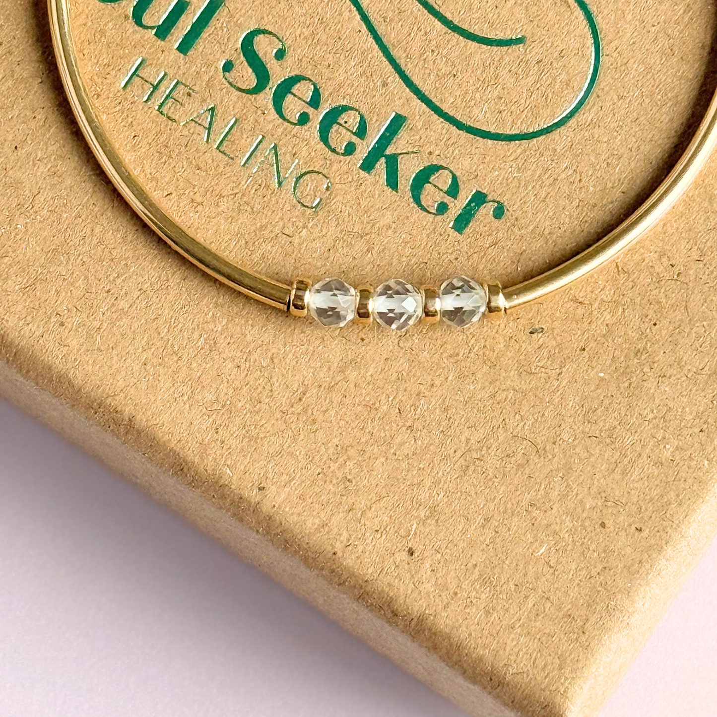 Gold filled elasticated stretch bracelet featuring five faceted clear quartz 4mm crystal beads, one to celebrate each decade for a 30th birthday present. April birthstone bracelet with gold filled tube beads and 3mm spacer beads.
 