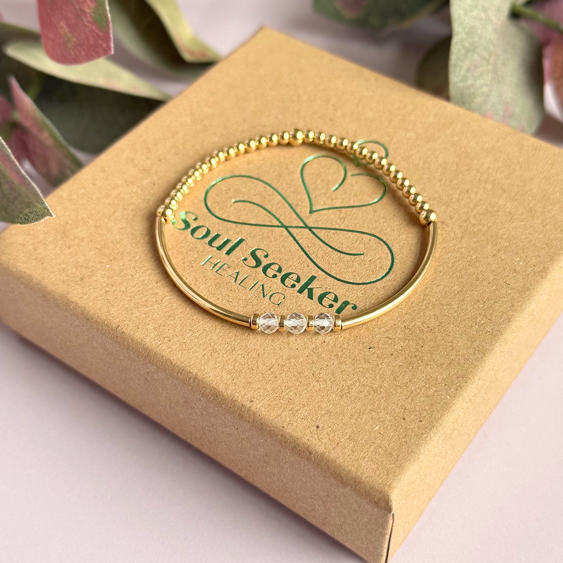 Gold filled elasticated stretch bracelet featuring five faceted clear quartz 4mm crystal beads, one to celebrate each decade for a 30th birthday present. April birthstone bracelet with gold filled tube beads and 3mm spacer beads.