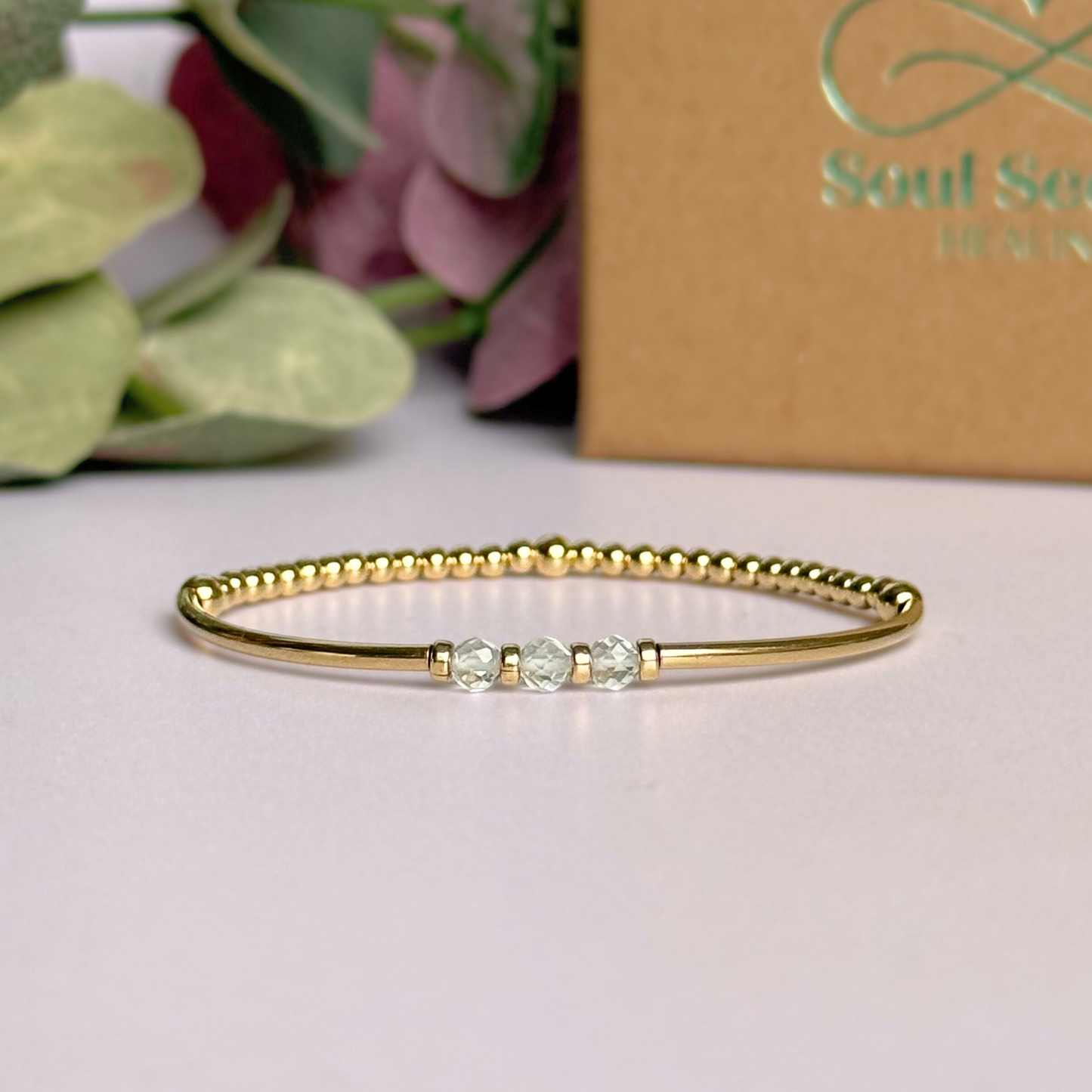 Gold filled elasticated stretch bracelet featuring five faceted clear quartz 4mm crystal beads, one to celebrate each decade for a 30th birthday present. April birthstone bracelet with gold filled tube beads and 3mm spacer beads.