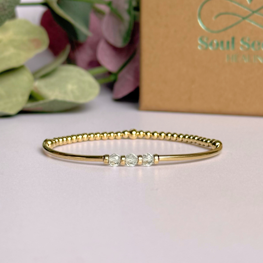 Gold filled elasticated stretch bracelet featuring five faceted clear quartz 4mm crystal beads, one to celebrate each decade for a 30th birthday present. April birthstone bracelet with gold filled tube beads and 3mm spacer beads.