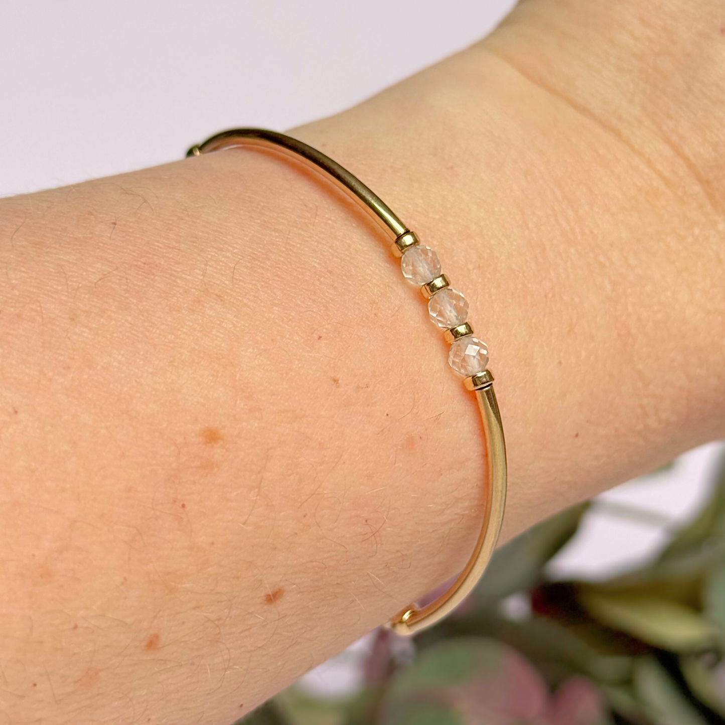 Gold filled elasticated stretch bracelet featuring five faceted clear quartz 4mm crystal beads, one to celebrate each decade for a 30th birthday present. April birthstone bracelet with gold filled tube beads and 3mm spacer beads.