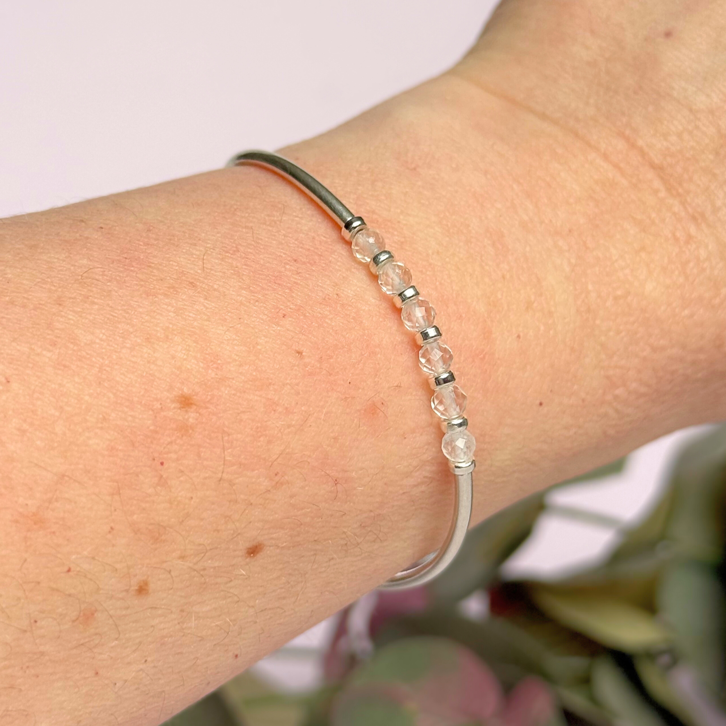 Sterling silver elasticated stretch bracelet featuring six clear quartz crystal beads, one to celebrate each decade for a 60th birthday present. With sterling silver tube beads and 3mm spacer beads.