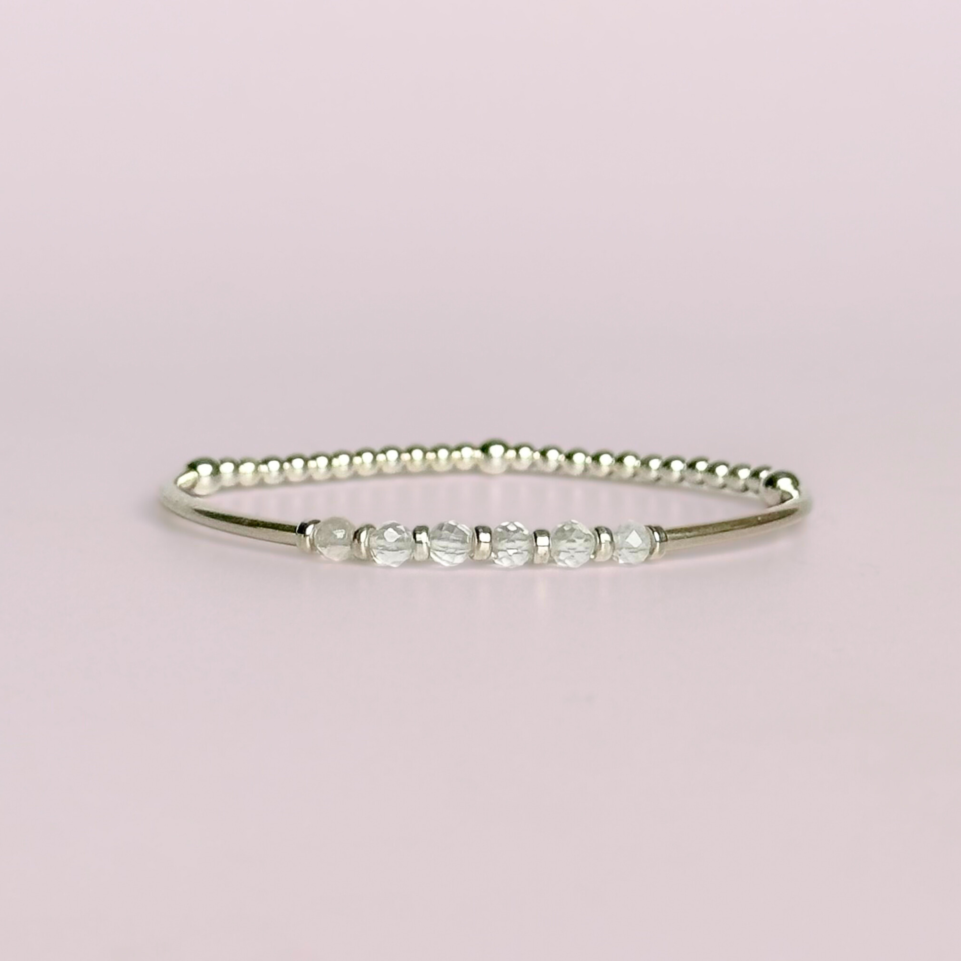 Sterling silver elasticated stretch bracelet featuring six clear quartz crystal beads, one to celebrate each decade for a 60th birthday present. With sterling silver tube beads and 3mm spacer beads.