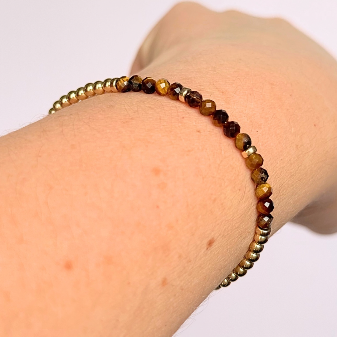 Dainty minimalist yellow gold filled crystal bracelet featuring 3mm faceted tigers eye beads with 3mm gold filled beads. Fastens with a gold filled lobster clasp with an extender chain.