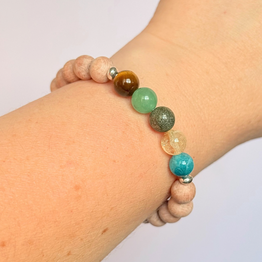 Essential oil diffuser bracelet with five crystals all believed to help with manifestation. Featuring raw rosewood beads to diffuse aromatherapy oils. With apatite, citrine, pyrite, green aventurine and tigers eye. All beads are 8 mm.