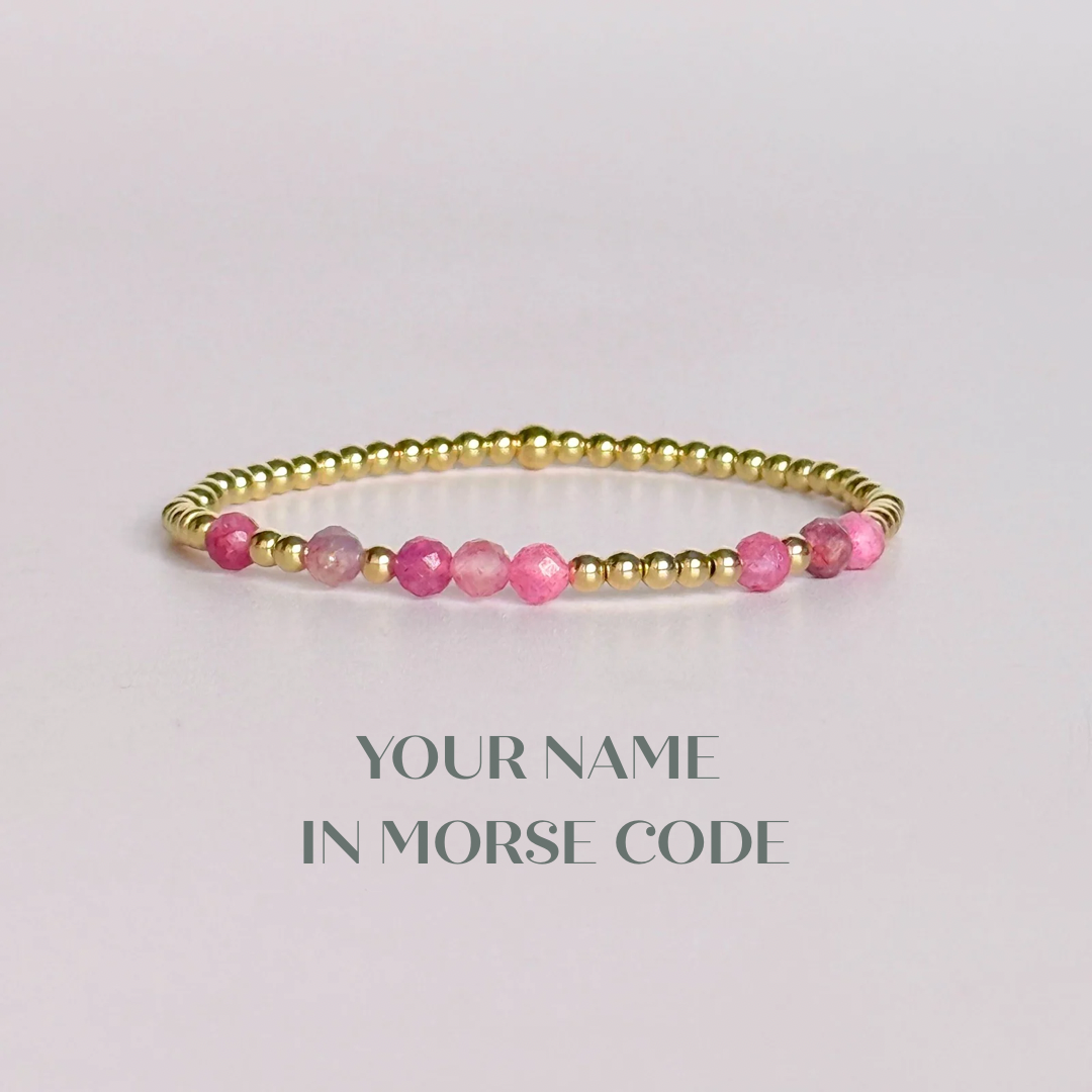 Morse code secret message bracelet spelling out your chosen name in gold filled and pink tourmaline crystal beads. Elasticated with 4mm faceted pink tourmaline beads and 3mm gold filled beads. Custom October birthstone bracelet.