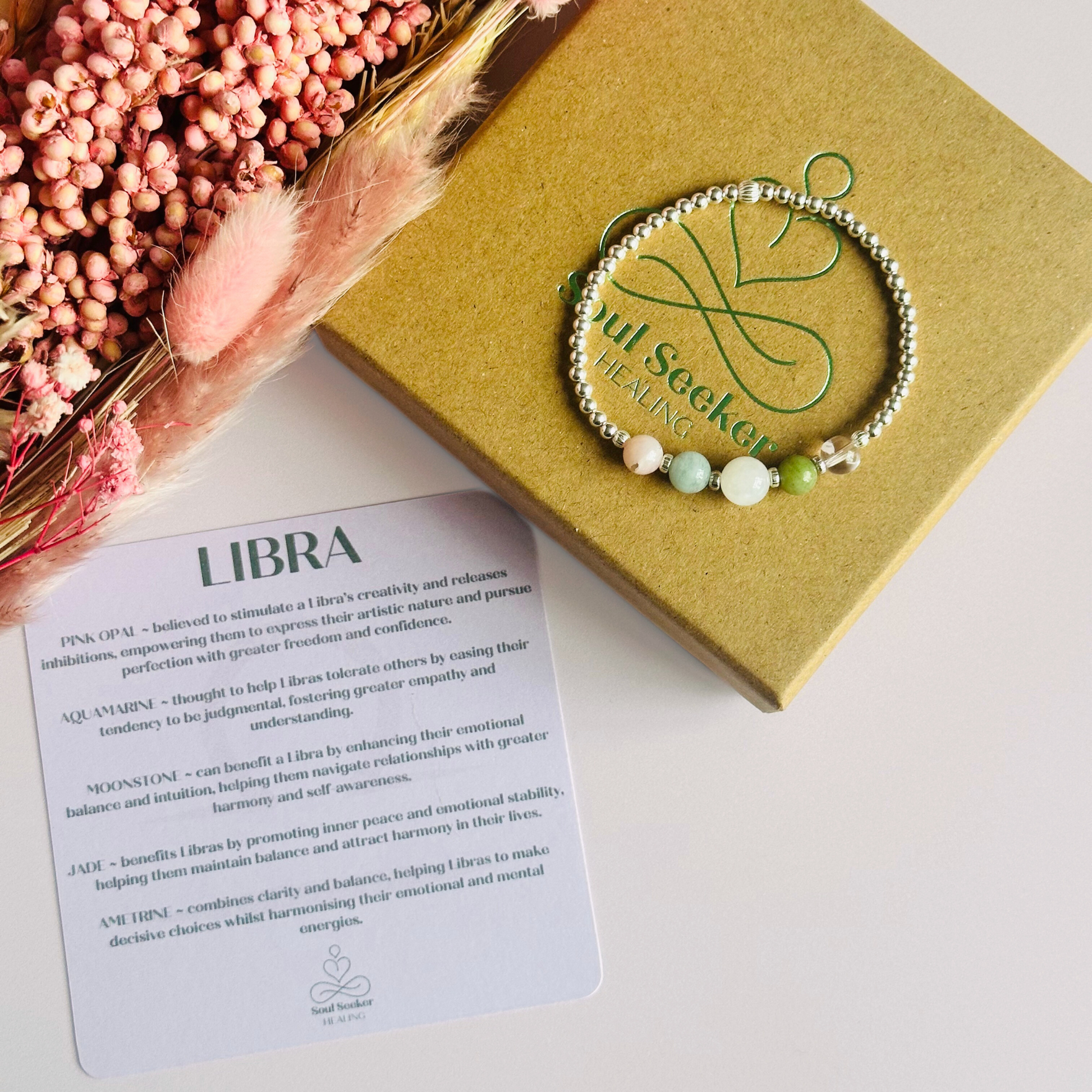 This sterling silver Libra bracelet is made with a selection of five healing crystals all believed to resonate with the Libra zodiac sign. The central bead is 8mm, the other four are 6mm. On an elasticated band of 3mm sterling silver beads with corrugated accent beads. Featuring ametrine, jade, moonstone, aquamarine and pink opal.