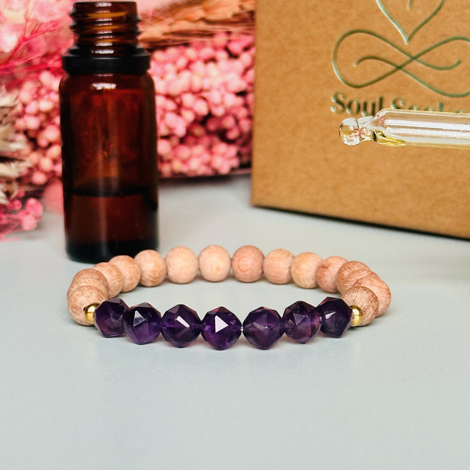 Amethyst and raw rosewood elasticated essential oil diffuser bracelet. Made with 8mm star cut amethyst beads, 8mm round raw rosewood beads and your choice of sterling silver, gold vermeil or rose gold vermeil spacer beads