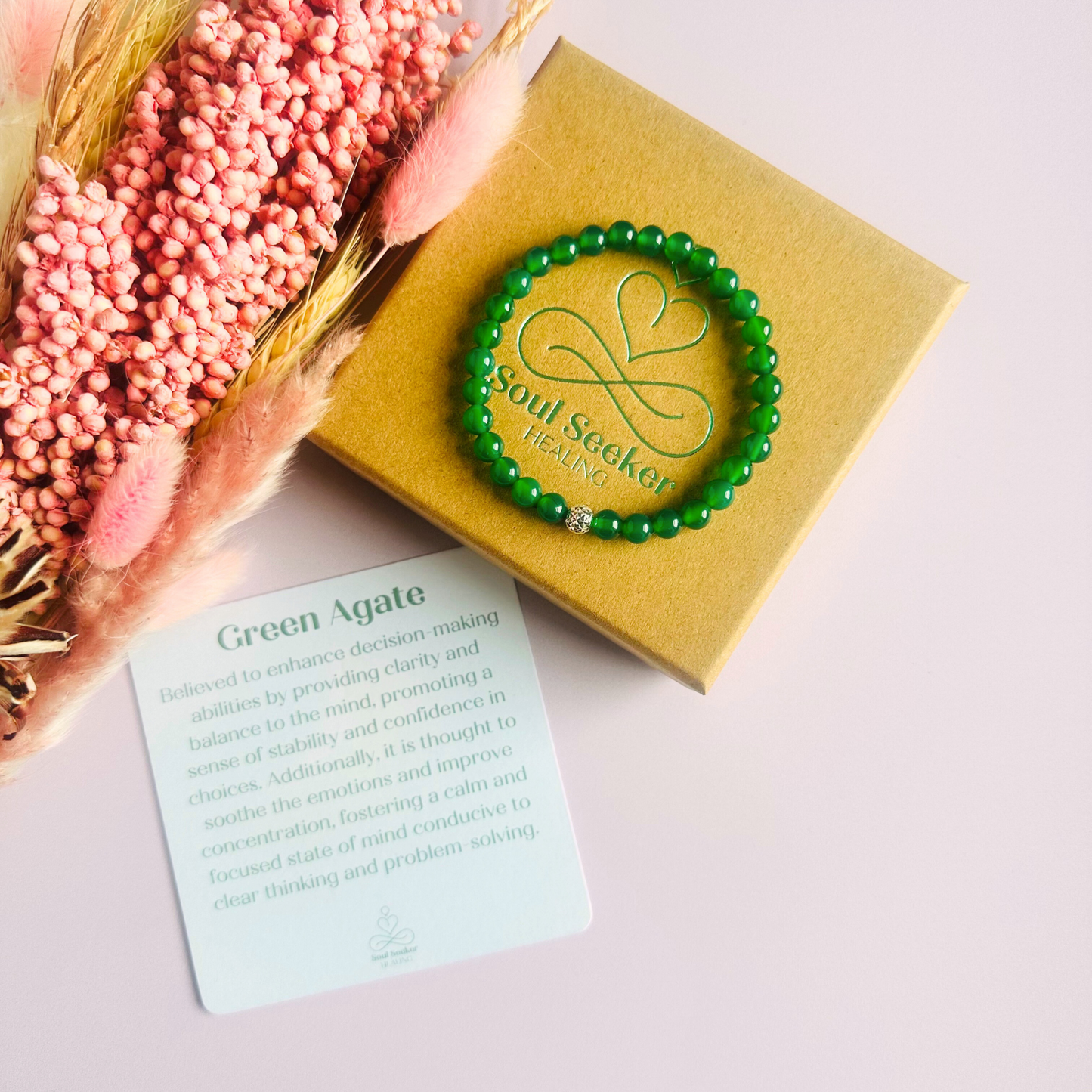 Green agate crystal healing bracelet made with 6mm smooth, round green agate beads and your choice of sterling silver or gold vermeil 6mm faceted focal bead. Elasticated for comfort. Pictured on eco-friendly gift box with crystal information card.