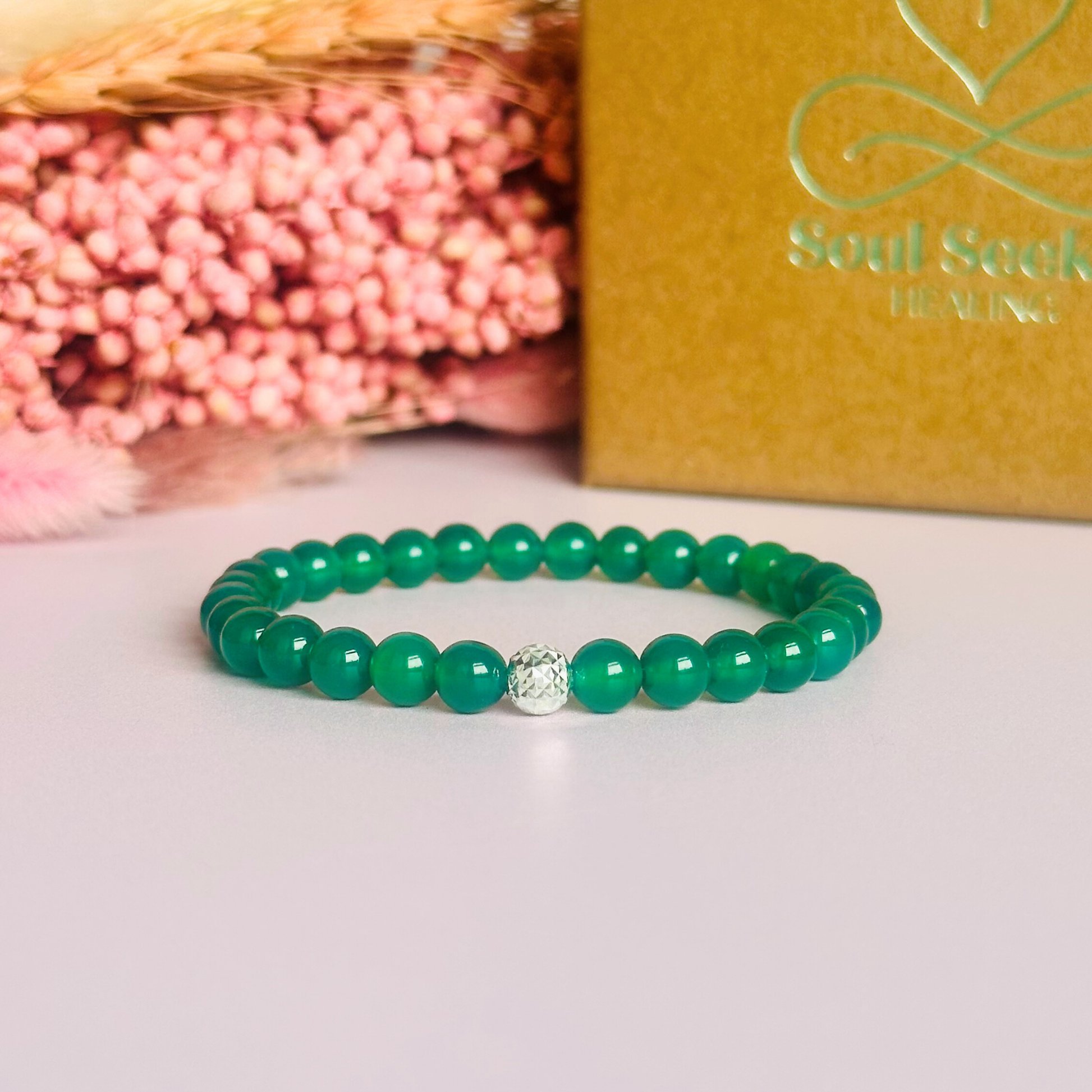 Green agate crystal healing bracelet made with 6mm smooth, round green agate beads and your choice of sterling silver or gold vermeil 6mm faceted focal bead. Elasticated for comfort.