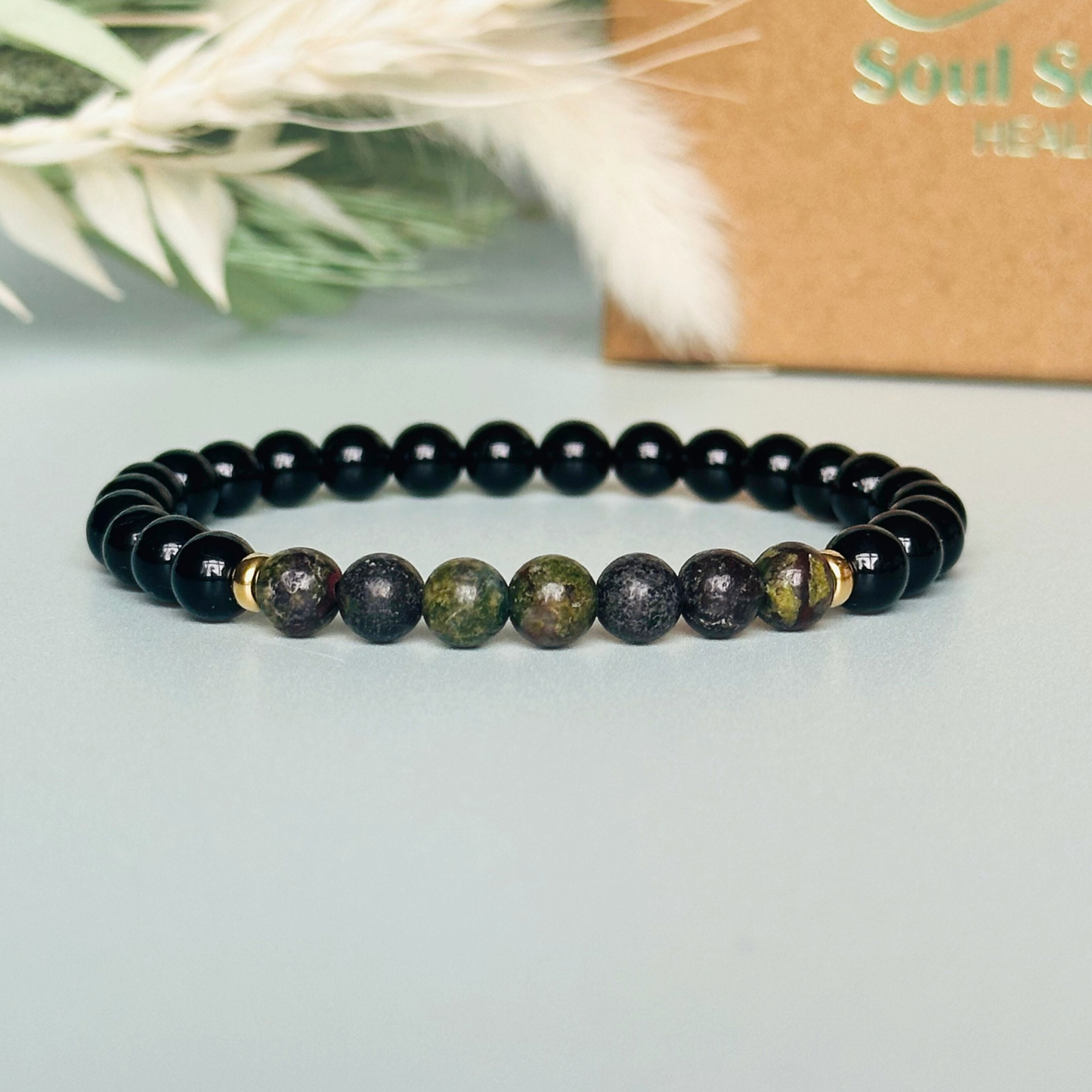 mens dragon blood jasper and black tourmaline bracelet with 6mm crystal beads. Gift box in background